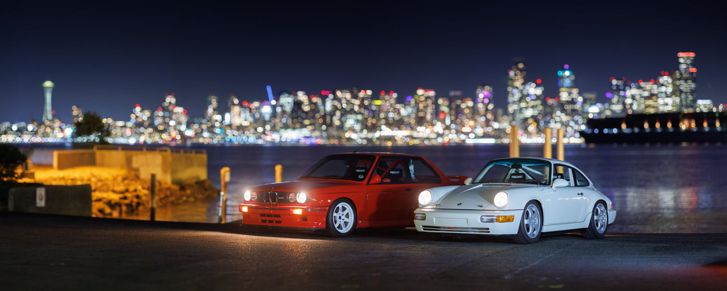 BMW E30 M3 and Porsche 964 cup car with Seattle in the background Horizontal shot 24 x 60 inches(2ftx5ft)